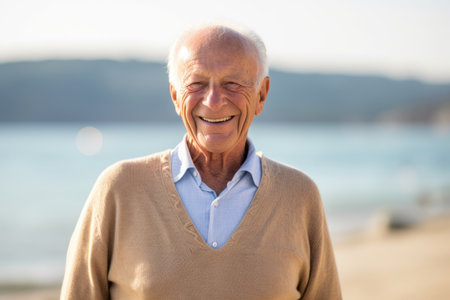 Portrait of a senior man smiling at the camera on the beachの素材