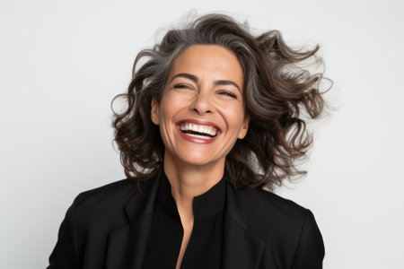 Close up portrait of a happy business woman laughing isolated over white backgroundの素材
