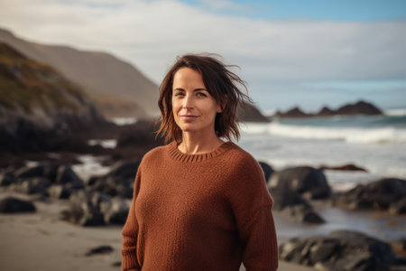 Portrait of a beautiful woman at the beach on a cold winter dayの素材