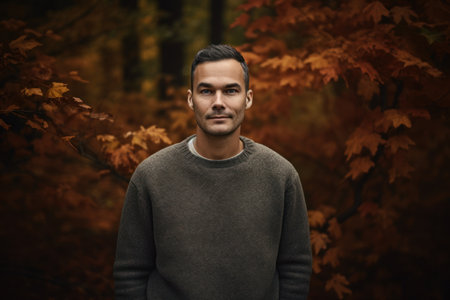 Portrait of a handsome man in the autumn forest. Men's beauty, fashion.の素材