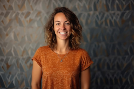 Portrait of a beautiful young woman with brown hair in an orange t-shirt.の素材