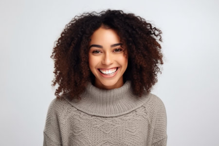 Portrait of a beautiful young african american woman smiling and looking at cameraの素材