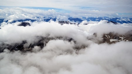 High above the everyday problems After the efforts made, a man reaching the top forgot their daily problems. Photos shot from the Zugspitze at 2962m, Alpesの写真素材