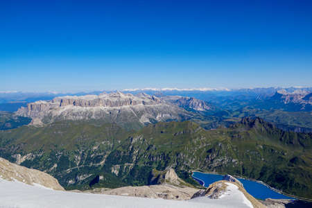 Wide panorama from Punta Rocca / 3265 m / of the Marmolada array towards Sella Group and Lake Fedaya, Dolomiti, Italy.の写真素材