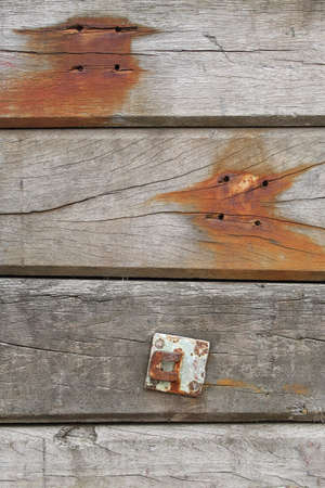 A close-up of old wooden beams covered with rust stainsの写真素材