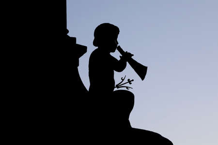 A silhouette of a Putto, a small statue of a child, blowing a horn on the Wilhelmina fountain in...