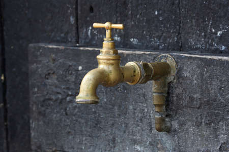 A close-up of a tap on the outside of a houseの写真素材