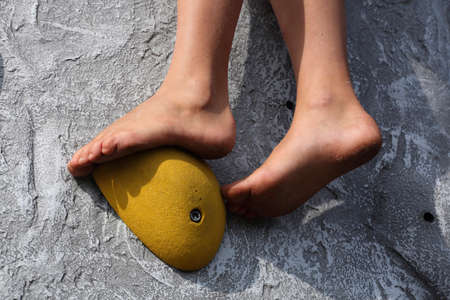 A close-up of the feet of a child climbing a mobile climbing wallの写真素材