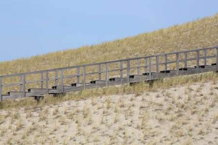 A wooden stairway in the dunes of Petten, the Netherlands, leading to a viewing pointの写真素材
