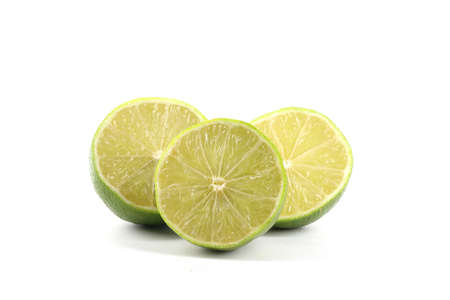 A close-up of limes isolated on whiteの写真素材