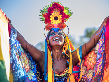 Beautiful Brazilian Woman of African Descent Wearing Colourful Costume and Smiling During 2016 Carnival Street Parade in Rio de Janeiro, Brazilのeditorial素材