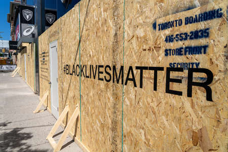 Toronto, Canada - June 6, 2020: Boarded up storefront in Downtown Toronto showing Black Lives Matter message written out front in support of social movement against racial injustice in North America.のeditorial素材