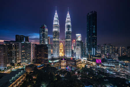 Kuala Lumpur City Centre aka KLCC complex including national landmark Petronas Twin Towers illuminated at night in Kuala Lumpur, Malaysia.のeditorial素材