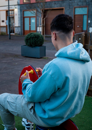 Boy swinging in children's toyの写真素材
