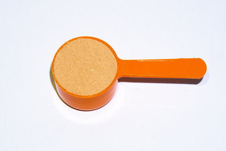 A serving of protein powder on white backgroundの写真素材