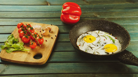 scrambled eggs fried eggs omelet with tomatoes and garlic in a rustic farmhouse style. tasty healthy breakfastの写真素材