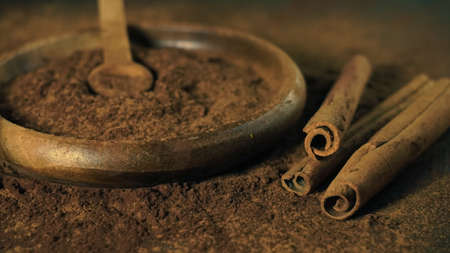 cinnamon ground sticks ceremony cocoa cloves ground coffee spices on wooden table closeupの写真素材