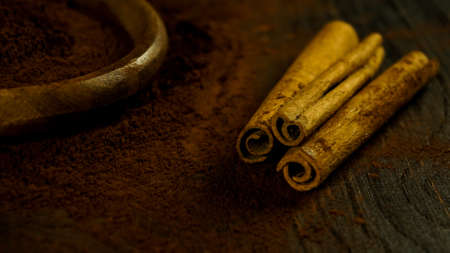 cinnamon ground sticks ceremony cocoa cloves ground coffee spices on wooden table closeup