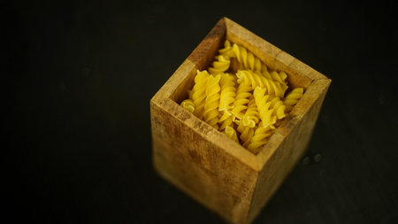 pasta in a dish dry appetizing spiral macaroni in the kitchen food preparation