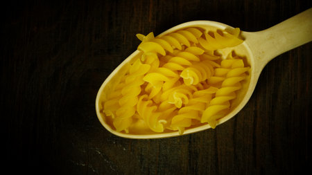 pasta in a dish dry appetizing spiral macaroni in the kitchen food preparationの写真素材