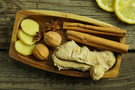 Ginger tea ingredients ginger lemon cinnamon clove saffron sage rustic close-upの写真素材
