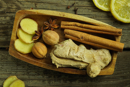Ginger tea ingredients ginger lemon cinnamon clove saffron sage rustic close-upの写真素材