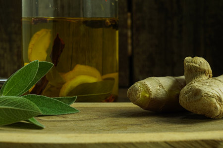 Ginger tea ingredients ginger lemon cinnamon clove saffron sage rustic close-upの写真素材