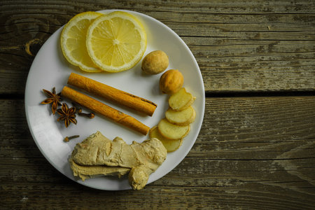 Ginger tea ingredients ginger lemon cinnamon clove saffron sage rustic close-upの写真素材
