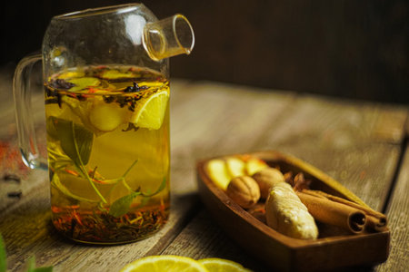 Ginger tea ingredients ginger lemon cinnamon clove saffron sage rustic close-upの写真素材