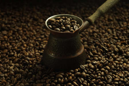 Black roasted coffee beans. Cezva cup coffee glass rustic style Turkish ground coffeeの写真素材