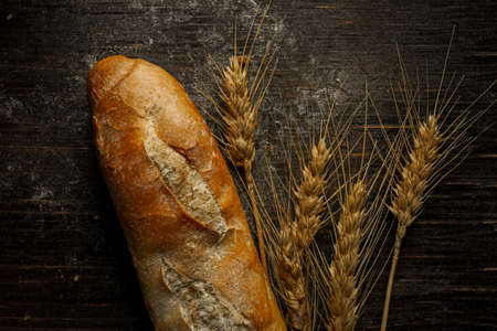 Fresh bread baguette loaf with seeds in a rustic style. Baking homemade healthy breadの写真素材