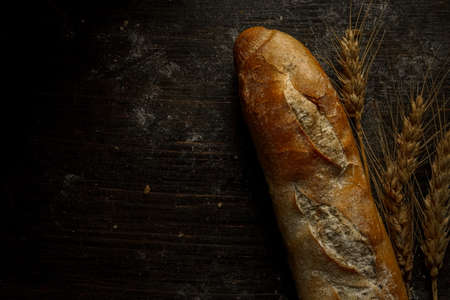 Fresh bread baguette loaf with seeds in a rustic style. Baking homemade healthy breadの写真素材