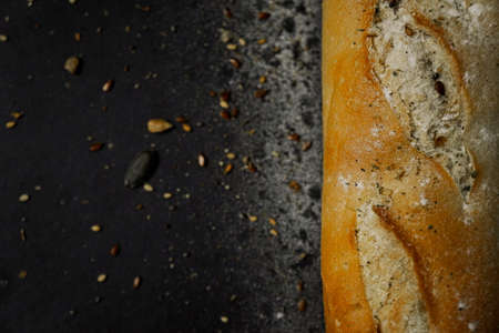Fresh bread baguette loaf with seeds in a rustic style. Baking homemade healthy breadの写真素材