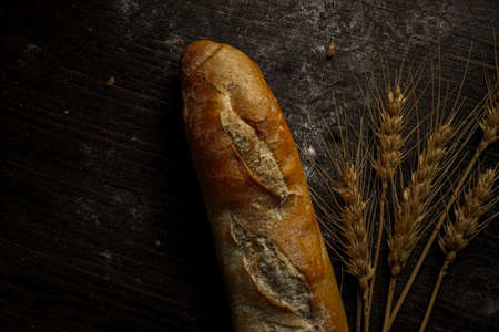 Fresh bread baguette loaf with seeds in a rustic style. Baking homemade healthy breadの写真素材