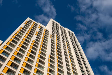 Modern building in a blue sky with cloudsの写真素材