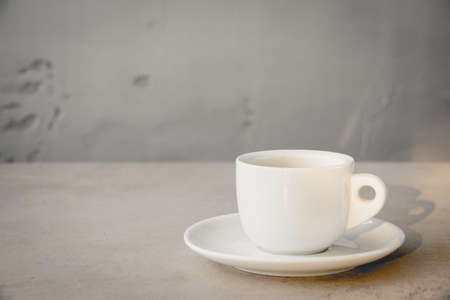 White Cup Espresso Morning Beverage Beautiful Shine Light and Shadow Concrete Wall Background...