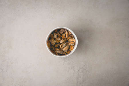 Peeled Mussel in Cup Filled with Water on Beige Table Fresh Sea Food Delicatessen Protein Top Viewの写真素材