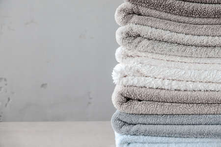 Stack Cotton Towel on Wooden Table Gray Background Copy Space Close Upの写真素材