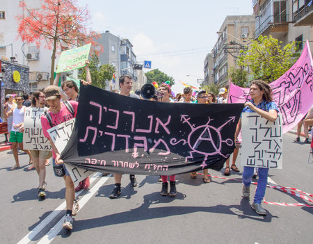 TEL-AVIV - JUNE 13, 2014  A group of anarchists march in the Pride Parade in the streets of Tel-Aviv, Israel  The pride parade is an annual event of the gay communityのeditorial素材