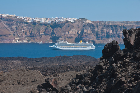 Volcanic rock  basalt  and the town of Fira, Santorini, Greeceの写真素材