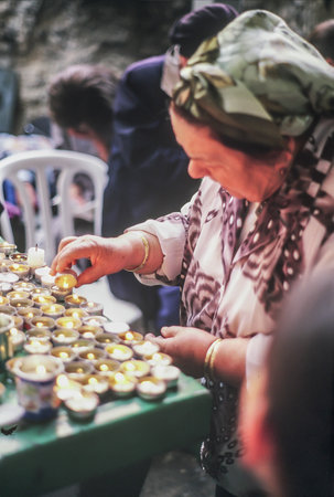 Mount Meron, Israel â May 09, 2004  Woman lighting a candle in the annual Jewish celebration of lag baomer on rabbi Shimon Bar Yochay tomb, mount Meron, Israelのeditorial素材