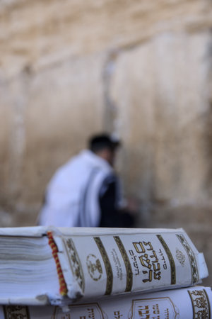 JERUSALEM - JULY 31 - Orthodox Jews prays at the Western Wall, behind praying book  Siddur  - July 31, 2013 in the old city of Jerusalem, Israel  This is the holiest place in Jewish traditionのeditorial素材