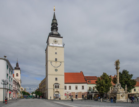 TRNAVA, SLOVAKIA - SEPTEMBER 24, 2013  Local and visitor stroll the Trojicne square, near the city tower, In Trnava, Slovakiaのeditorial素材