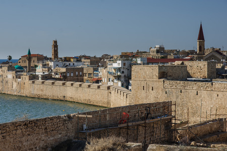 View of the city walls and the fishing harbor, the old city of Acre, Israel