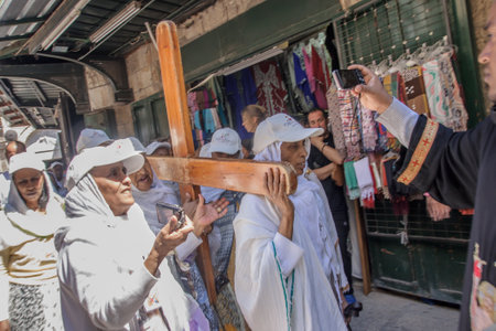 JERUSALEM - APRIL 18, 2014  Pilgrims from all over the world commemorating the crucifixion of Jesus Christ by carrying a cross along via dolorosa, on good Friday, in the old city of Jerusalem, Israelのeditorial素材