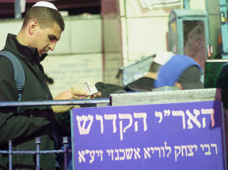 SAFED, ISRAEL - OCTOBER 02, 2014: Jewish man prays Selichot (request for forgiveness) at the tomb of The ARI (Rabbi Isaac Luria), on Yom Kippur eve, in Safed, Israel.のeditorial素材