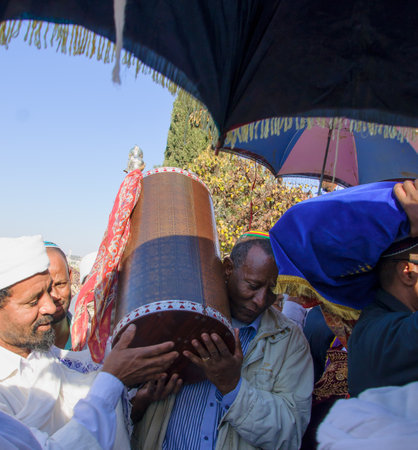 JERUSALEM - NOV 20, 2014: An Ethiopian Jewish man and a Kes, religious leader of the Ethiopian Jews, carrying the holy torah book, at the end of the annual Sigd holiday prays, in Jerusalem, Israelのeditorial素材