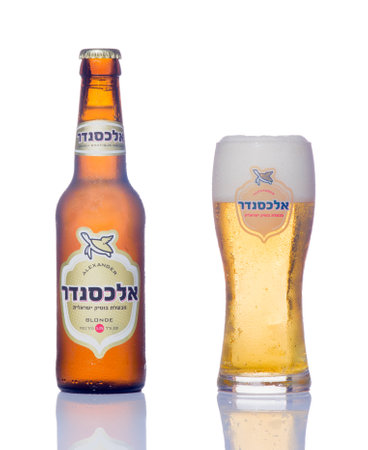 HAIFA, ISRAEL - SEP 27, 2014: A bottle and a glass of alexander blonde beer, winner of the European beer star competition in 2014 (English-Style Golden Ale category) in Haifa, Israelのeditorial素材