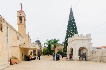 NAZARETH, ISRAEL - December 19, 2014: Local and visitors, and a Christmas tree, in the Greek Orthodox Church of Annunciation, in Nazareth, Israelのeditorial素材