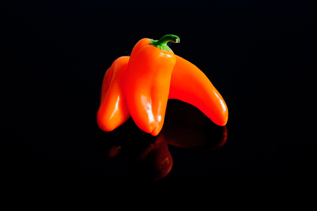 Small peppers on a black surfaceの写真素材